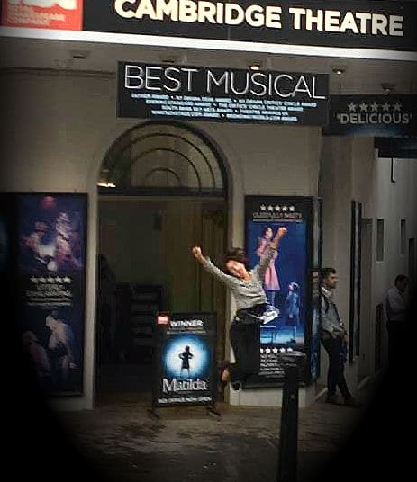 Girl jumps in front of West End Theatre in London.
